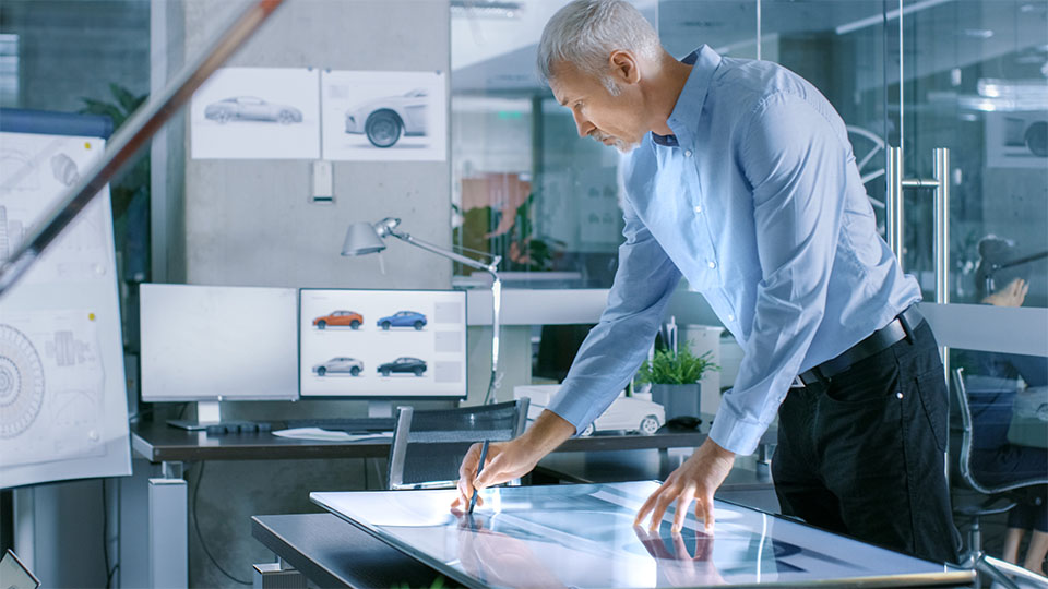 Car designer digitally sketching a car exterior
