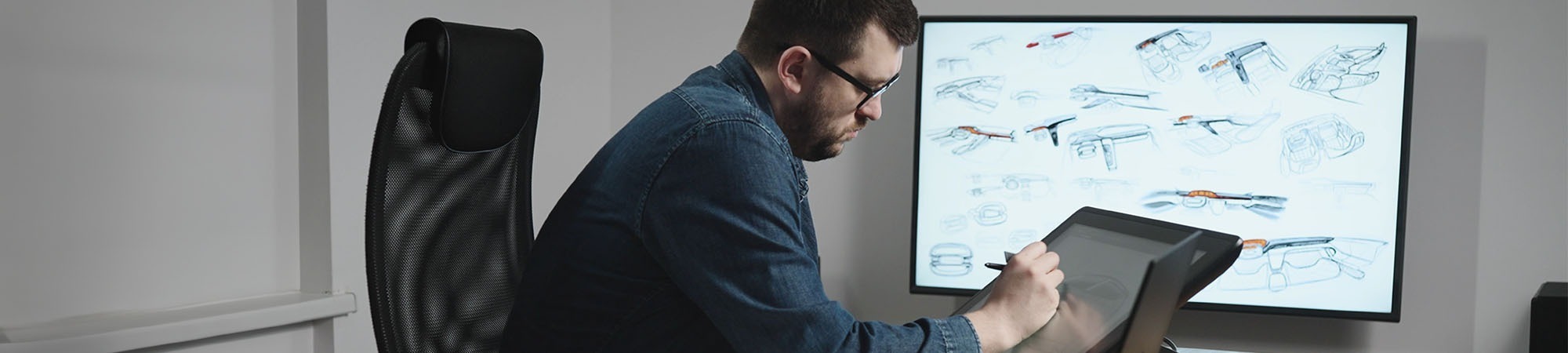 Automotive designer sketching a car exterior on a screen