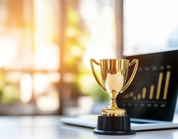 Trophy in front of a laptop on a table