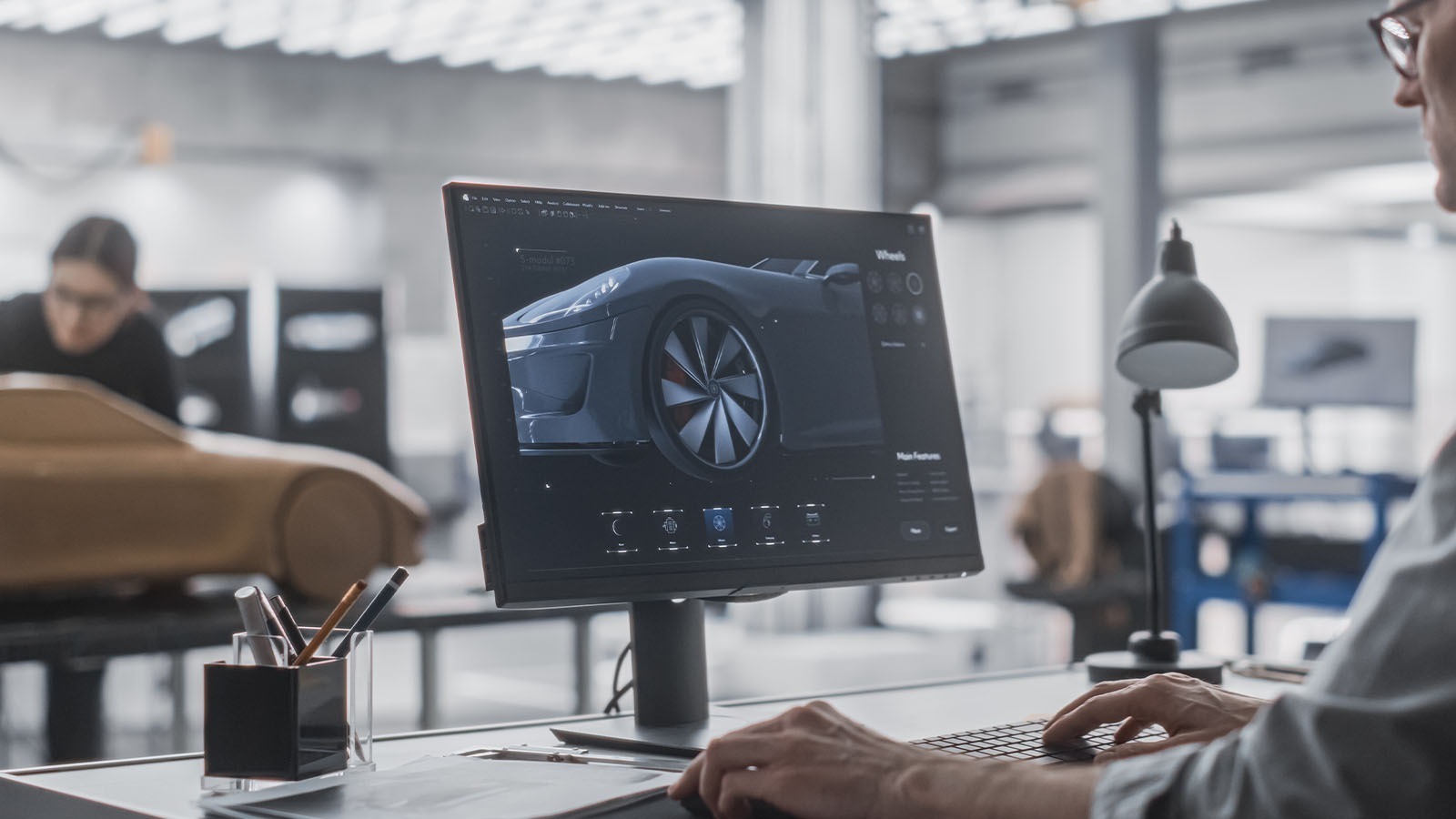 CAD model on computer screen in automotive design studio